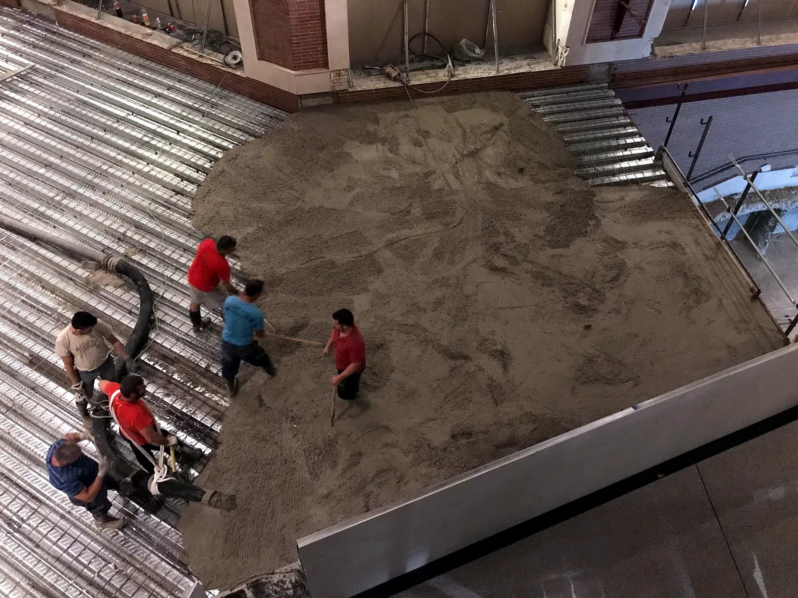 Equipo hormigonando una pasarela, visto desde arriba